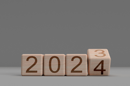 wooden blocks on a gray background with 2023 changing to 2024