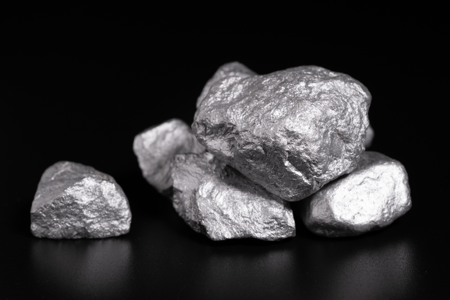 rare earth metals sitting on a black surface