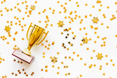 gold trophy with star confetti