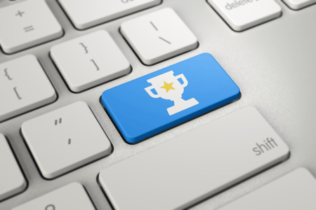 white keyboard with blue button displaying trophy