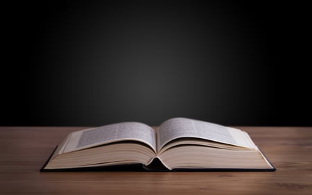 open book on a wooden table 