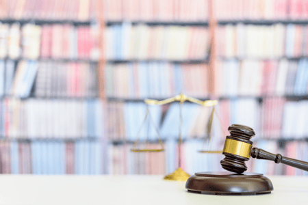 gavel with colored books behind it