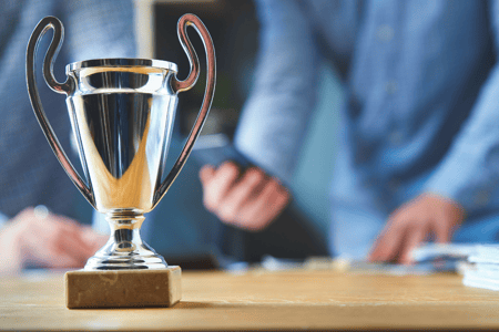 an award sits in front of a blurred person
